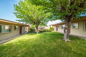 Farmington apartment for rent - a yard with some trees in front of some houses
