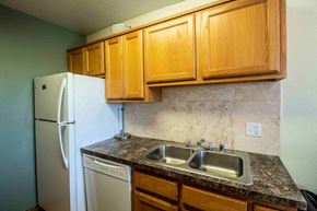 Farmington apartment for rent - a kitchen with a sink and a refrigerator