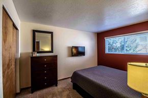 Farmington apartment for rent - a bedroom with a bed and a dresser in it