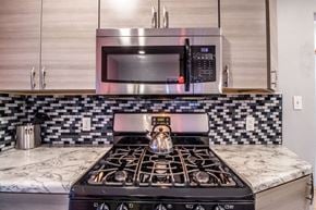 Farmington apartment for rent - a kitchen with a stove and a microwave