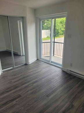 Chateauguay apartment for rent - a living room with a hard wood floor and sliding glass doors