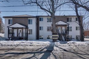 Chateauguay apartment for rent - a row of houses with snow in front of them