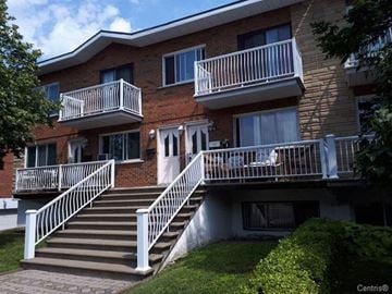 Saint-Laurent apartment for rent - a brick building with stairs and balconies