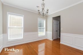 Lawrenceville house for rent - a dining room with wood floors and white walls and a chandelier