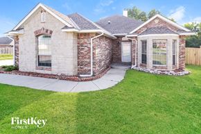 Moore house for rent - A brick house with a stone pathway leading to the front door.
