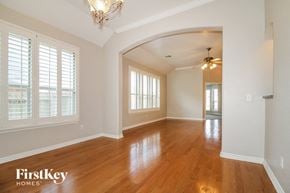 Moore house for rent - A well-lit room with wooden floors and a chandelier.