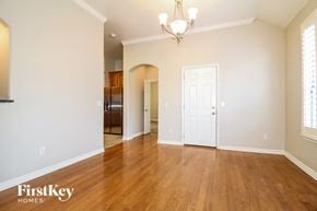 Moore house for rent - A room with wooden floors and a chandelier.