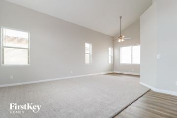 Buckeye house for rent - a living room with a rug and a ceiling fan