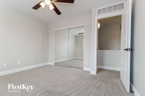 Buckeye house for rent - a bedroom with a closet and a ceiling fan