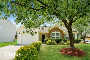Raleigh house for rent - a home with a large tree in front of it