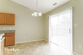 Raleigh house for rent - an empty kitchen and living room with a large window