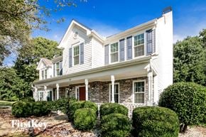 Hiram house for rent - a white house with white shutters and a red door