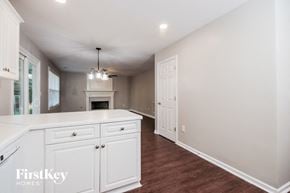 Hiram house for rent - a white kitchen with white cabinets and a fireplace