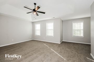 Hiram house for rent - the living room with carpet and a ceiling fan