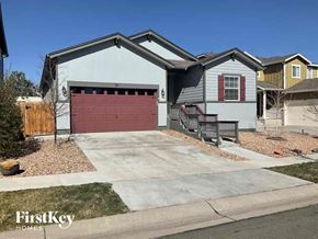 Brighton house for rent - a house with a red garage door in front of a driveway