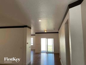 Brighton house for rent - an empty living room with white walls and a glass door