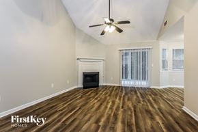 Newnan house for rent - A spacious room with a fireplace and wood flooring.