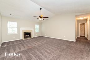 Mcdonough house for rent - the living room has a fireplace and a ceiling fan