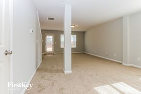 Covington house for rent - A spacious room with a carpeted floor and white walls.