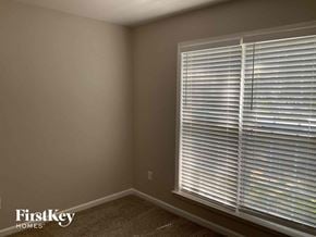 Charlotte house for rent - a bedroom with a large window with white blinds