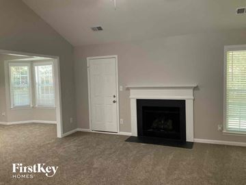 Charlotte house for rent - a living room with a fireplace and a white door