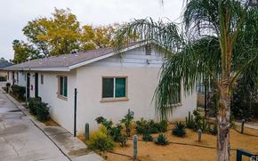 San Bernardino apartment for rent - a white house with a palm tree in front of it