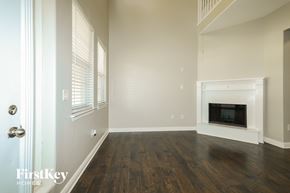 Montgomery house for rent - A room with a fireplace and wooden floors.