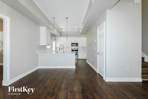 Montgomery house for rent - A kitchen with wooden floors and white walls.