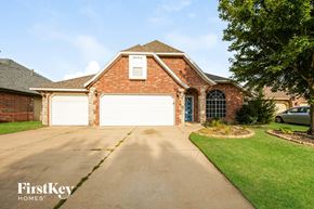 Oklahoma City house for rent - A brick house with a garage door is for sale.