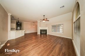 Oklahoma City house for rent - A spacious living room with wood flooring and a fireplace.