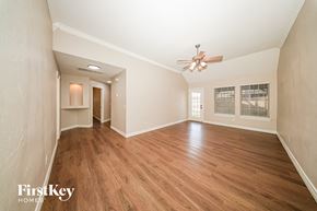 Oklahoma City house for rent - A room with wooden floors and a ceiling fan.