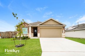 Bulverde house for rent - a home with a driveway and a garage door