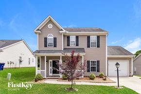 Winston-Salem house for rent - A house with a grey facade and a white door is shown.