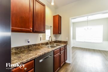 Winston-Salem house for rent - A kitchen with wooden cabinets and a granite countertop.