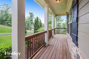 Ball Ground house for rent - a covered porch with a view of the yard and trees