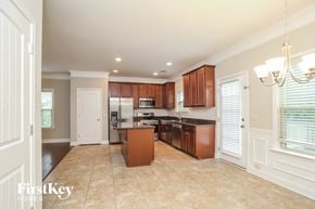 Ball Ground house for rent - a kitchen with wooden cabinets and a counter top