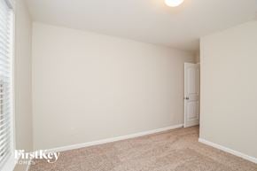 Ball Ground house for rent - a bedroom with white walls and carpet and a door