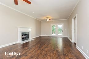 Antioch house for rent - an empty living room with a fireplace and a ceiling fan