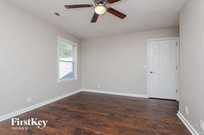 Antioch house for rent - a bedroom with a ceiling fan and a white door