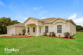 Lehigh Acres house for rent - a house with a lawn in front of it