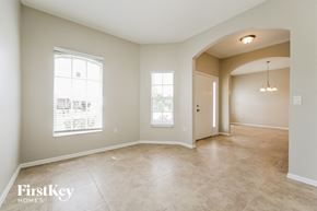 Lehigh Acres house for rent - an empty living room with a door and a window