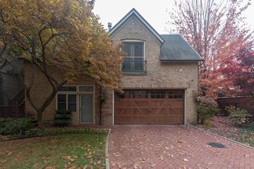 Chicago apartment for rent - a brick house with a driveway and a garage door