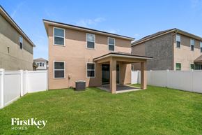 Jacksonville house for rent - a house with a grass lawn and a covered patio