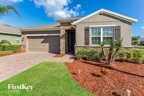 Palm Bay house for rent - A house with a brown roof and a garage door is shown.
