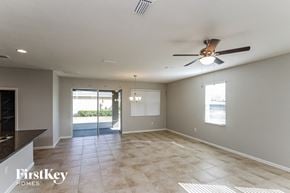 Palm Bay house for rent - A spacious room with a ceiling fan and tiled floor.