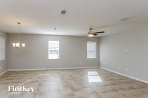 Palm Bay house for rent - A spacious room with a ceiling fan and two windows.