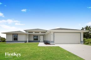 Lehigh Acres house for rent - the exterior of a house with a lawn and a driveway