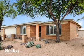 Tucson house for rent - a small brick house with a tree in front of it