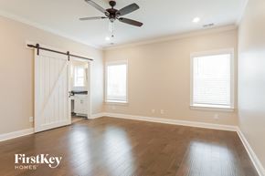 Helena house for rent - an empty room with a ceiling fan and a sliding door