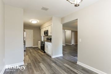 Jacksonville house for rent - a renovated kitchen and living room with wood flooring